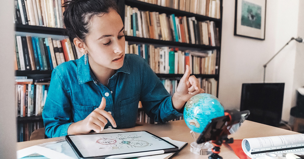 Student looking at a globe