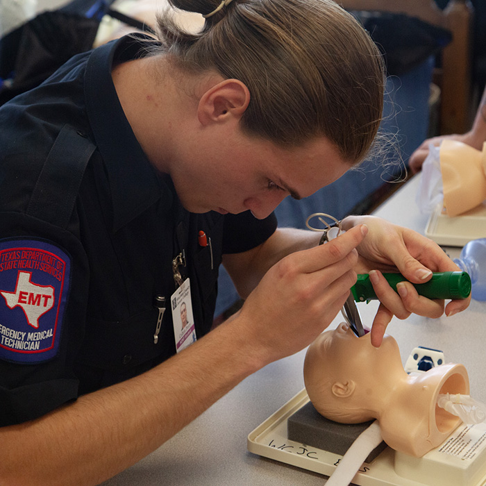 Student practices clearing a person's airway 