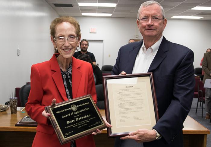 WCJC Board of Trustees Chair J. Paul Pope presents a plaque and resolution to Betty McCrohan upon her retirement.