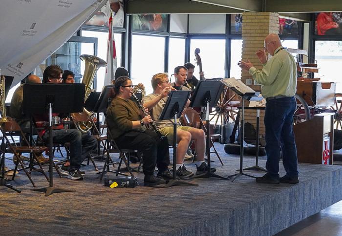 Wharton County Junior College Band members follow Band Director Joe Waldrop's guidance as they rehearse for the upcoming 