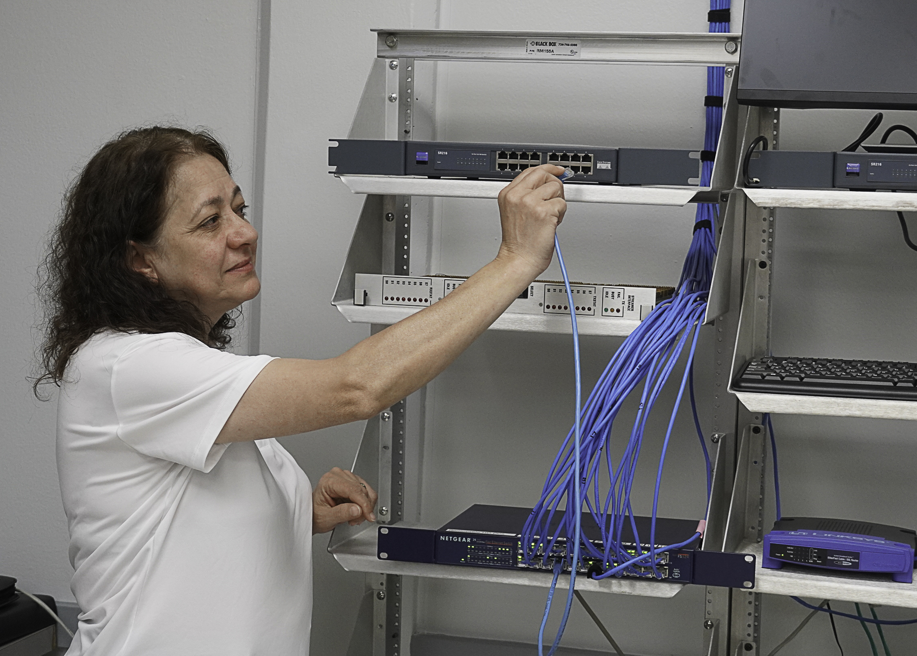 Wharton County Junior College's Dr. Muna Saqer, Program Director for the IT & Networking and Computer Science programs, demonstrates training equipment at the Wharton campus. State grant funds will enable the IT & Networking program to upgrade equipment, expand curriculum and provide scholarships. 